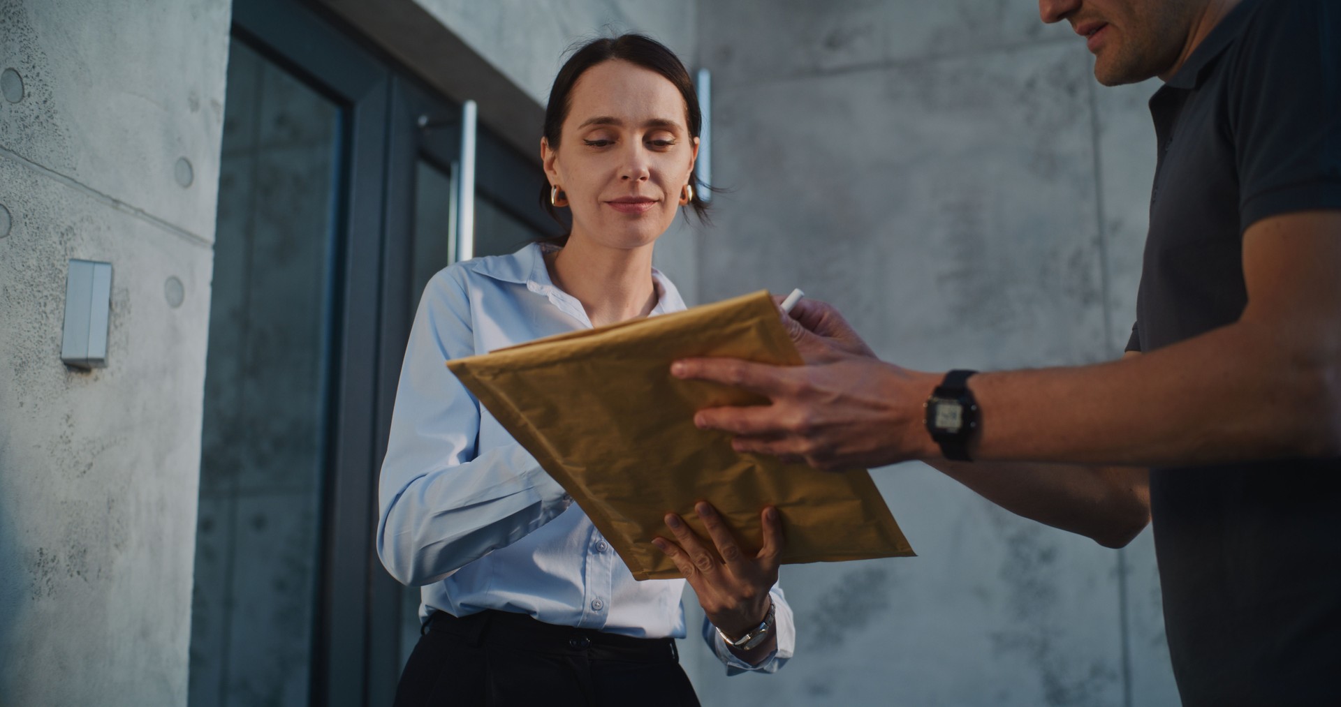 Postman Delivering Small Parcel for Recipient in Modern Office, Getting Client's Signature